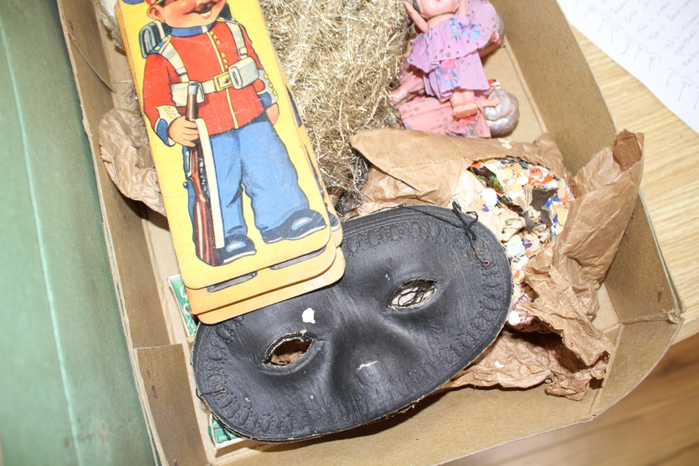 A collection of assorted curios, mostly vintage Christmas decorations but including masks and paper cut-outs